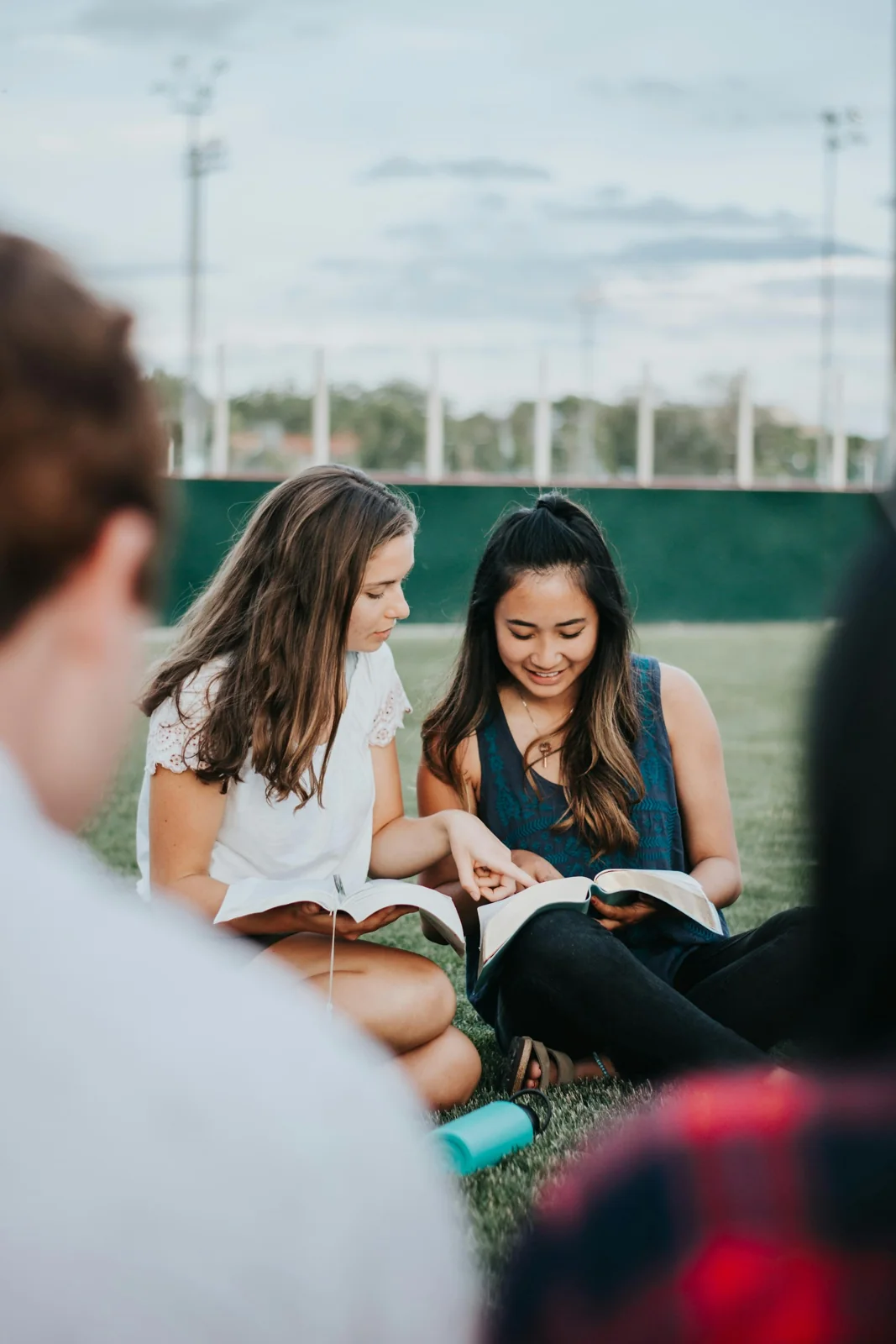 A group gathered around an open Bible